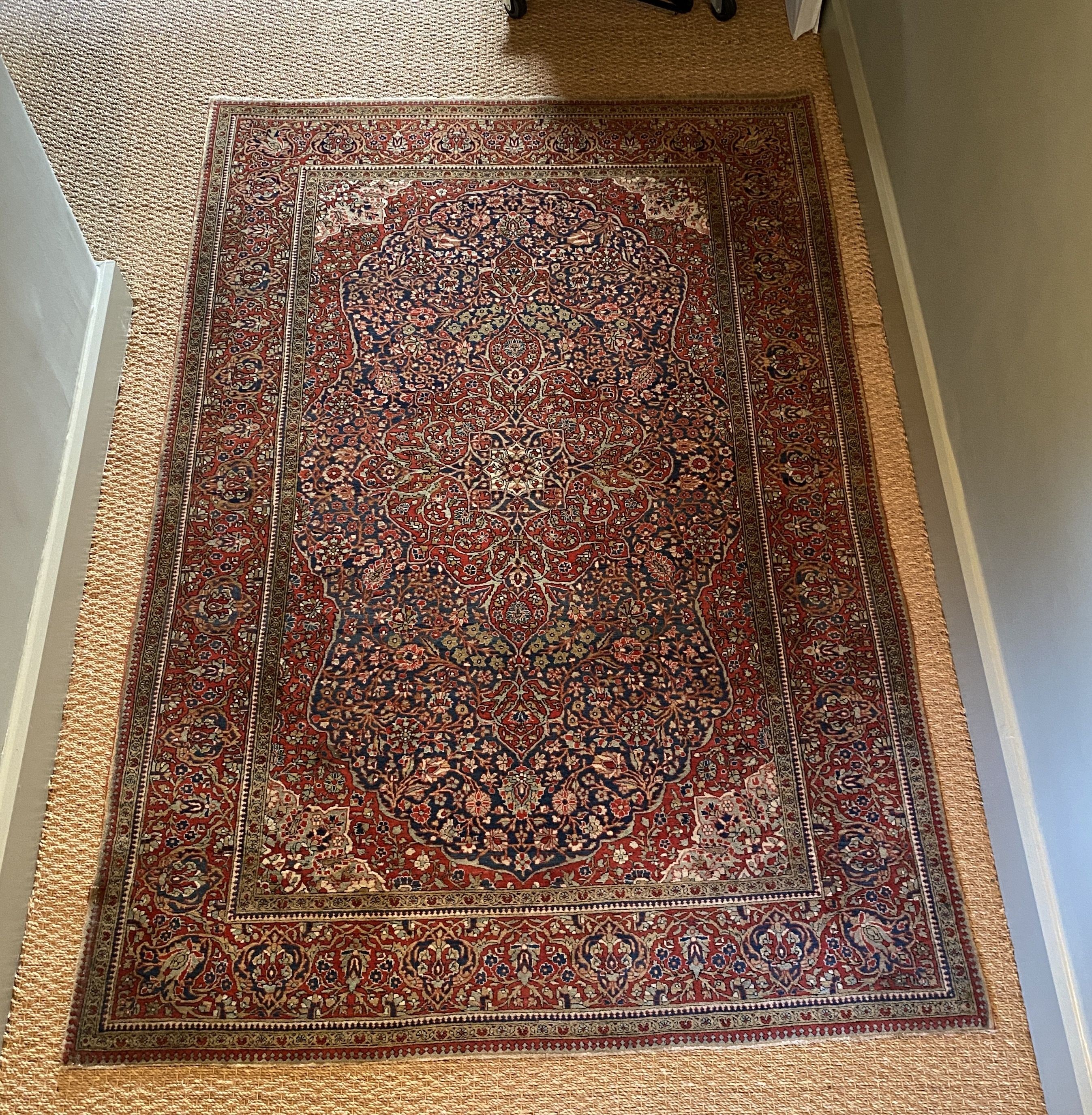 A fine Isphahan red ground rug, with central floral medallion, multi-bordered, 197 x 129cm